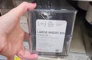 She grabs a pack of 2 plastic Walmart storage bins for this easy way to hide a common eyesore