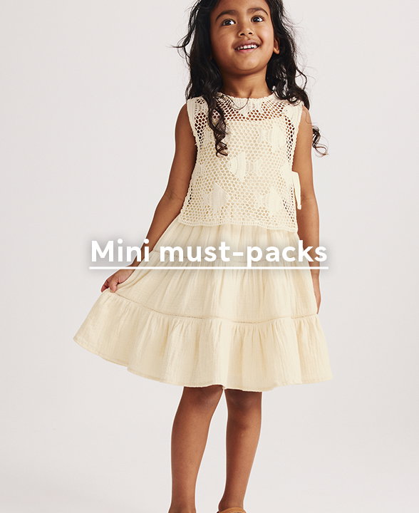 Girl wearing Pure Cotton Crochet Fish Sleeveless Dress in Buttermilk