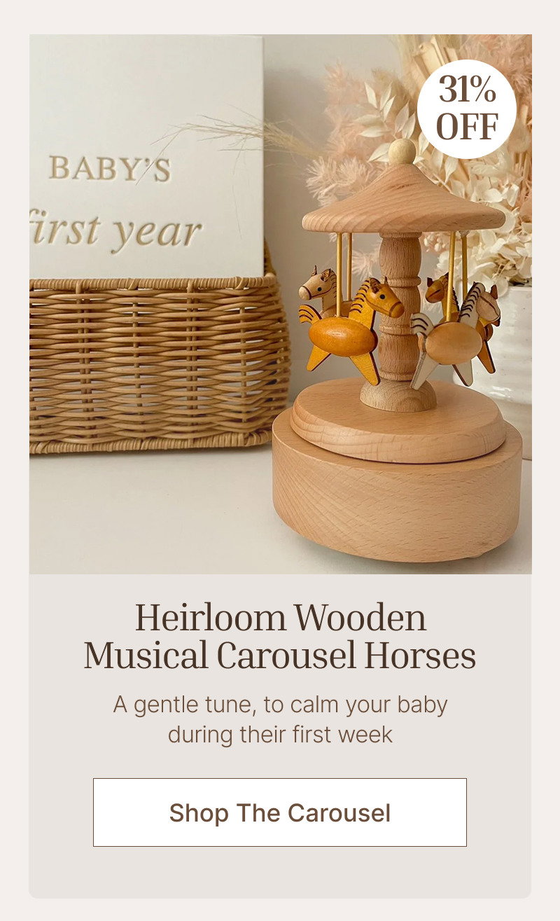 Wooden musical carousel beside a woven basket and baby book on a soft cream background with a circular product frame.