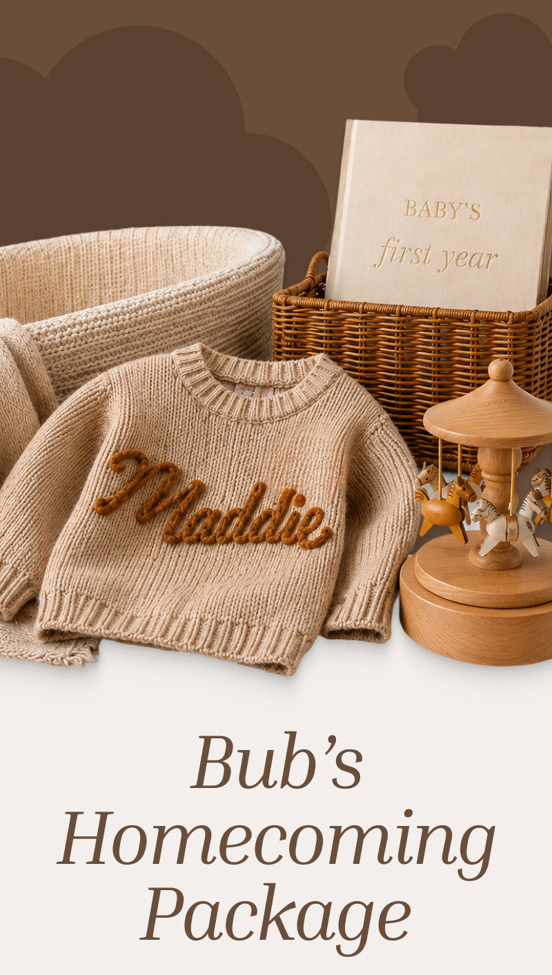Flat lay of a personalized knit blanket, woven basket, wooden carousel, and framed print above the title Bub’s Homecoming Package.