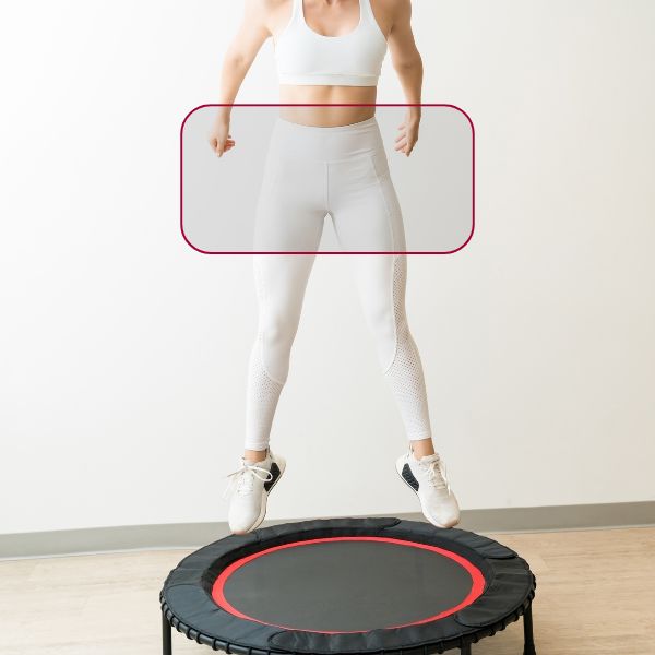 A woman jumping on a trampoline, with a highlight on her pelvic floor area.