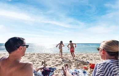 Family relaxing at the beach.
