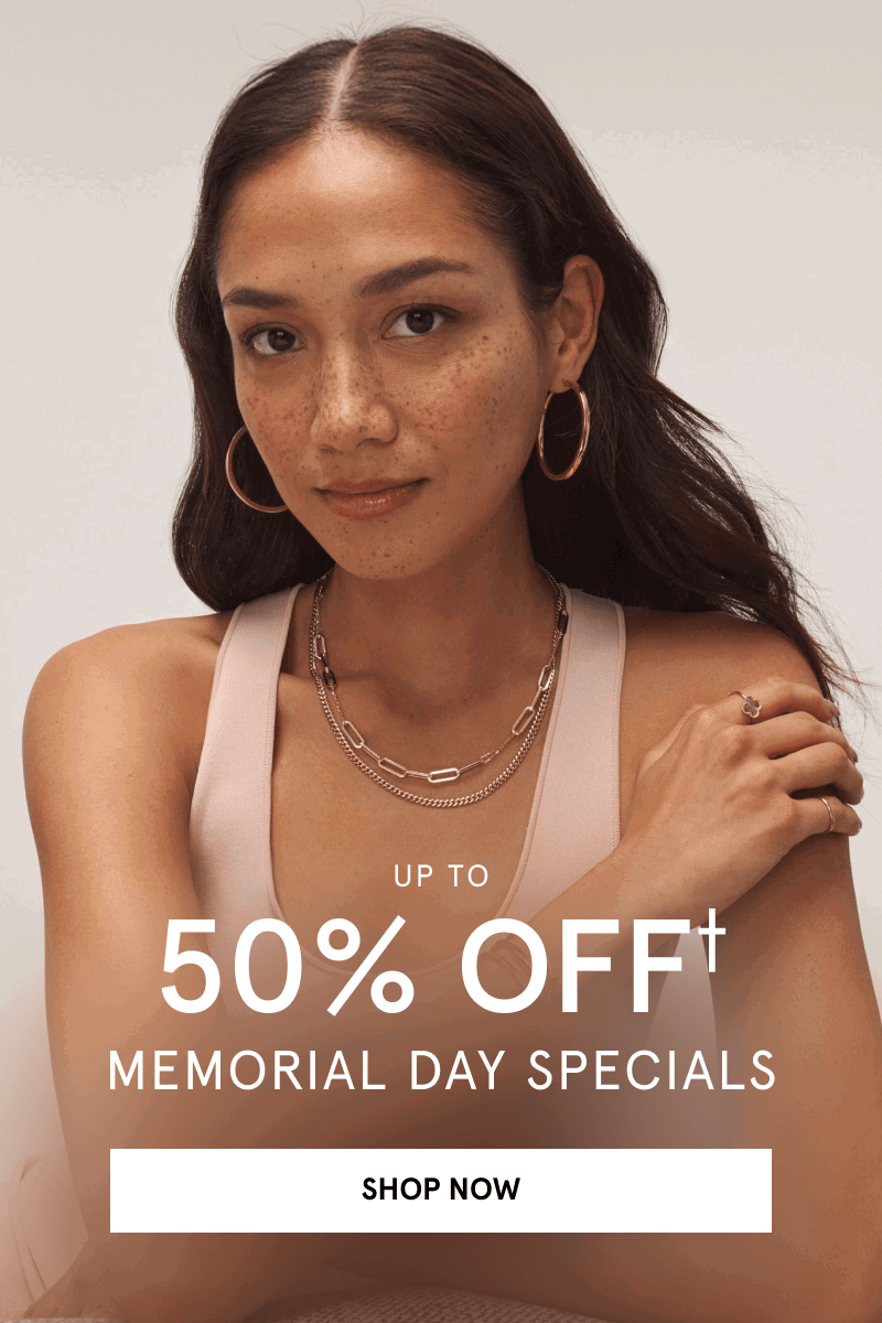 Woman wearing yellow gold hoops, layered chains, and fashion rings. Up to 50% Off Memorial Day specials. Click shop now.