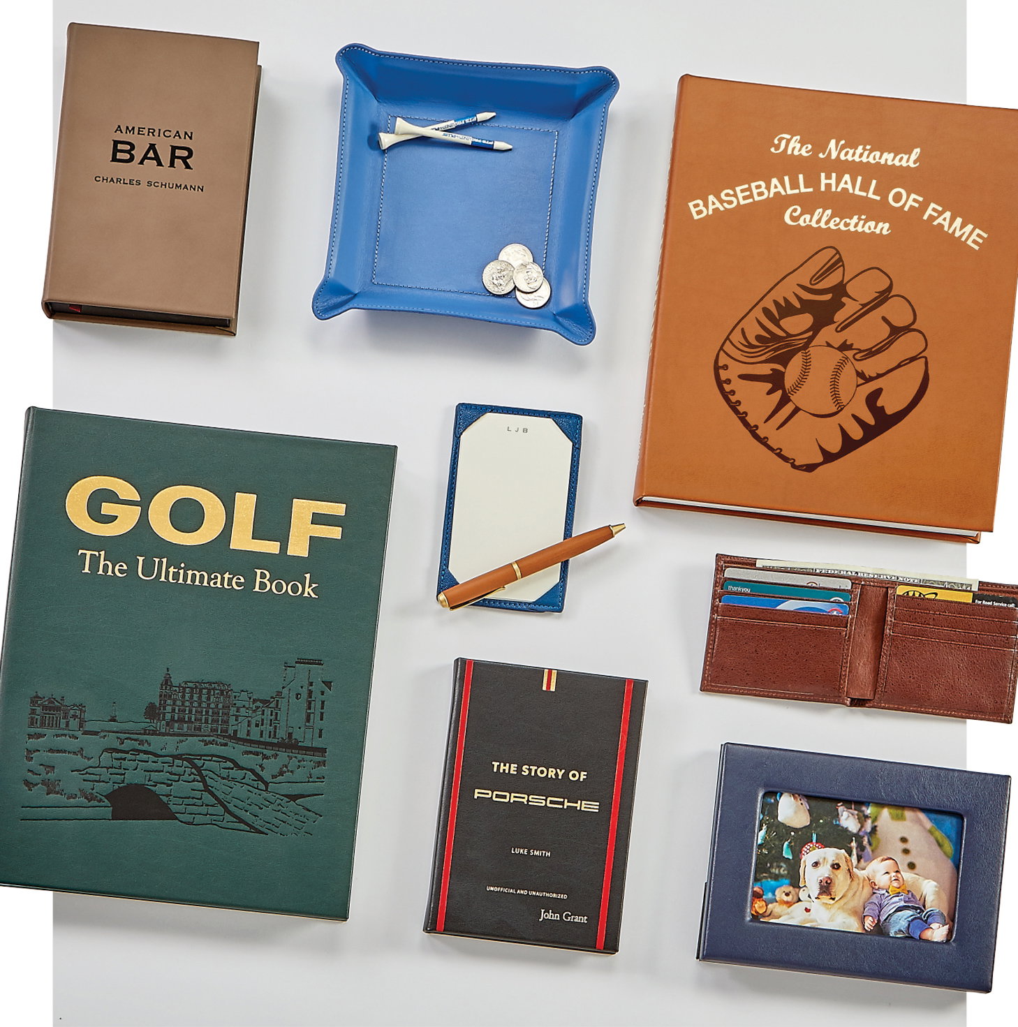 Leather-bound books on various sports and hobbies featured with other personal items.