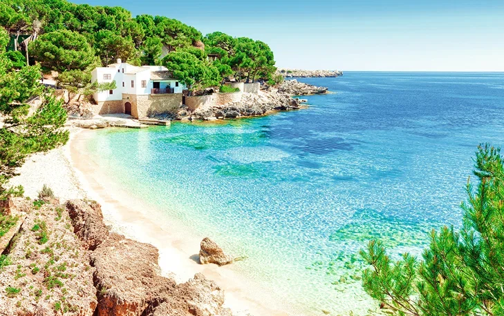 Beach in Majorca in a quite cove with crystal blue waters.