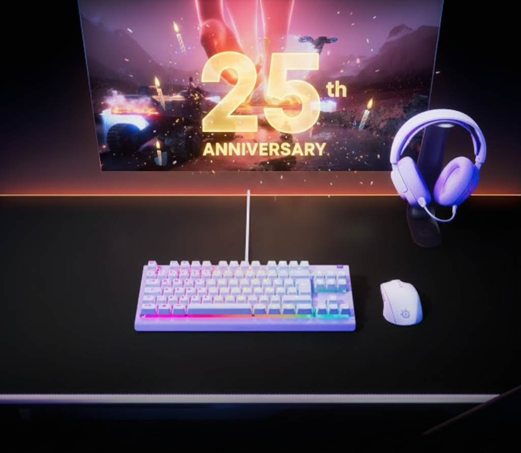 A gaming keyboard, mouse, and headphones sit on a desk in front of a screen celebrating "25th Anniversary."