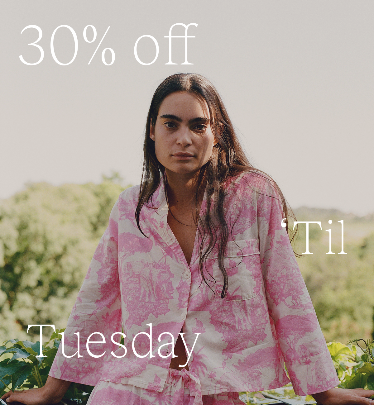 Model wearing pink printed Desmond & Dempsey pyjamas outdoors, with text reading “30% off ’til Tuesday.”