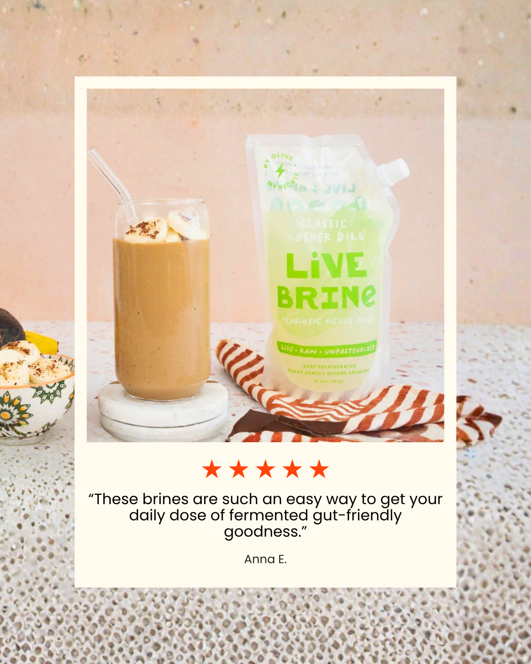 Overhead view of a Live Brine probiotic pickle juice pouch next to a banana smoothie, a bowl of banana slices, and a customer review.