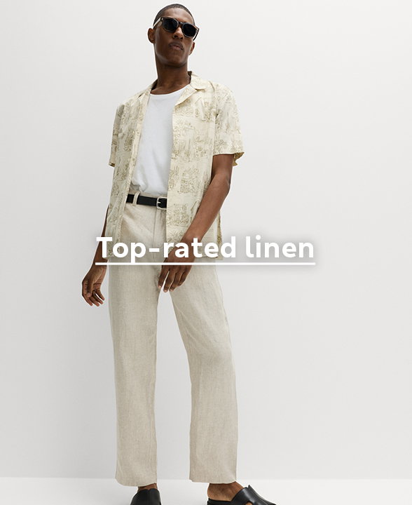 Man wearing Pure Linen Half- Elasticated Waist Trousers in Natural with a Short Sleeved Shirt and Black Sandals