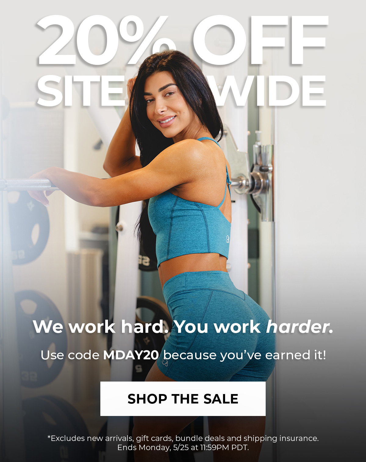 Model in teal active set standing in gym with Memorial Day Sale graphics and 20% off sitewide messaging.