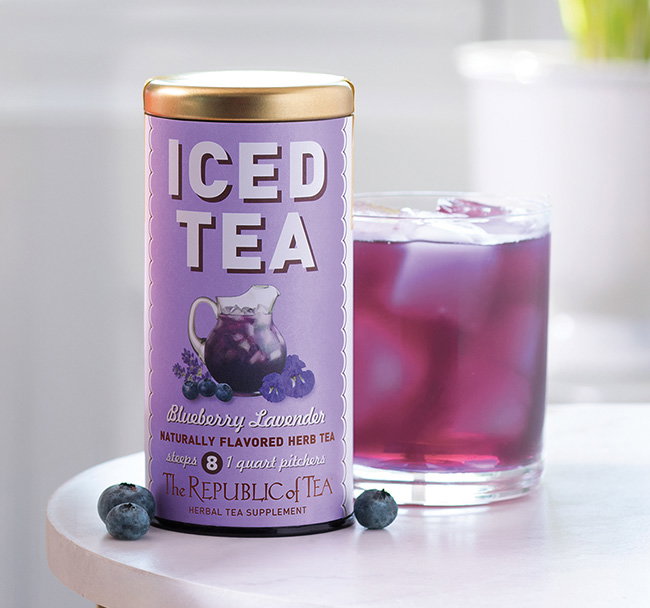 Blueberry Lavender tin with a mocktail next to tin in a living room environment