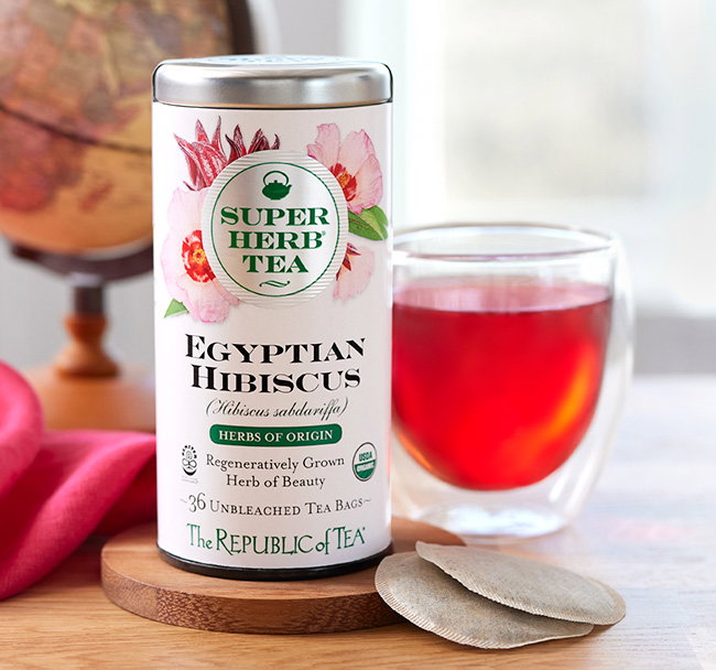 Egyptian Hibiscus tin with a teacup and world globe in the background
