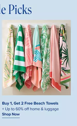 Buy one get 2 free beach towels. Plus up to 60% off home and luggage. A rack of hanging beach towels.