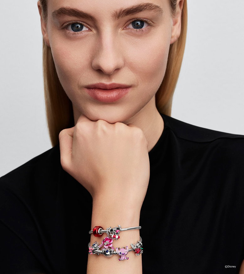 Model wearing Stitch charms on bracelet