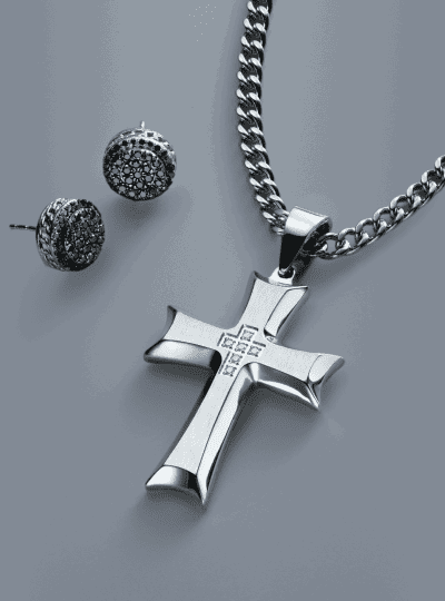 Men’s cross pendant necklace in silver tone metal with matching black diamond stud earrings.