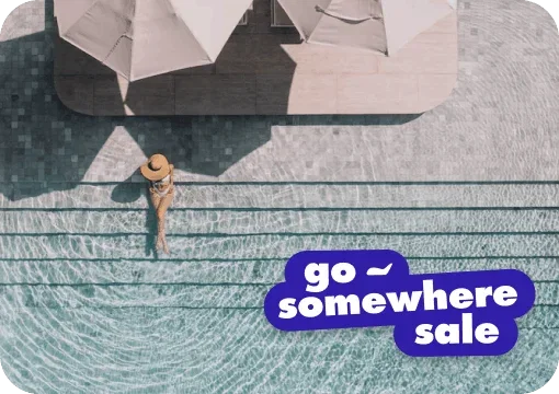Person sitting on steps at a pool