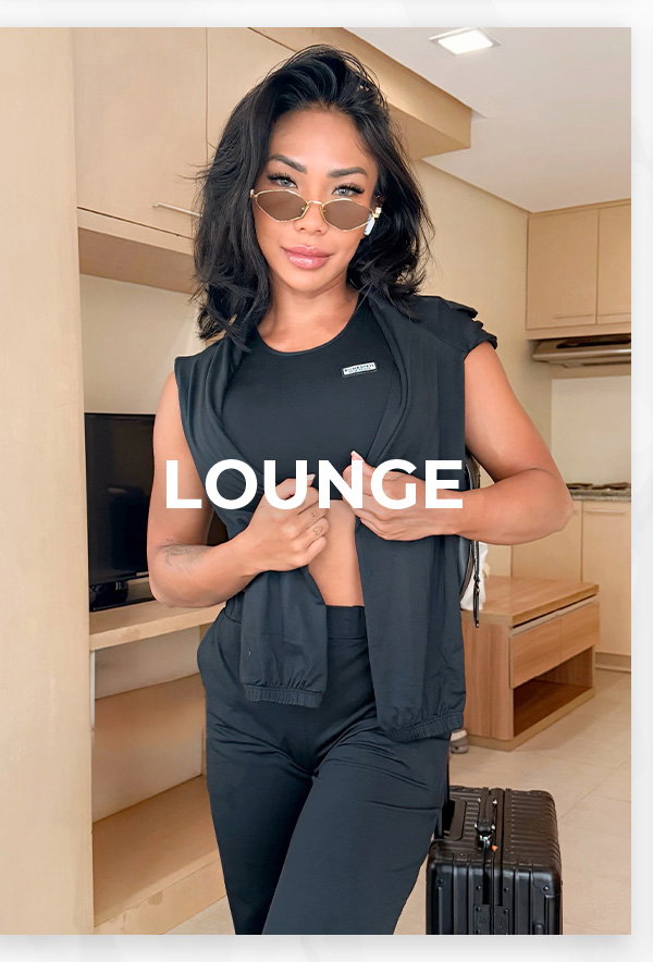Model in black lounge set with suitcase featured in Lounge category.