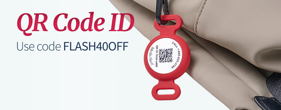 Close-up of a tan canvas bag, with a red silicone tag for a QR Code ID attached to a zipper with a small black clip. The round tag prominently displays a QR code and contact information. Dark red text in the top corner reads 'QR Code ID. Use code FLASH40OFF'.