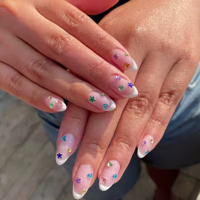 Blinged-out French tips are having a moment this summer.
