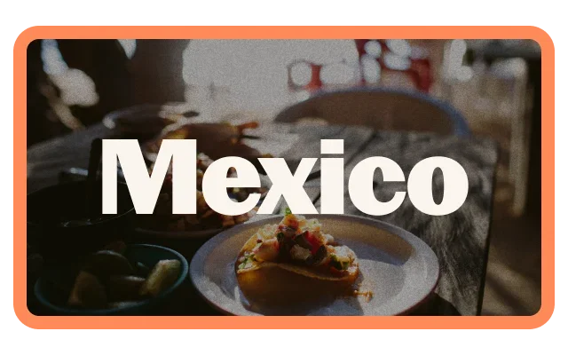 Coral-orange border, 'Mexico' white bold text with black outline, blurred Mexican food background, white plate with taco, colourful toppings, dark bowl with green peppers, warm restaurant lighting and rounded corners.