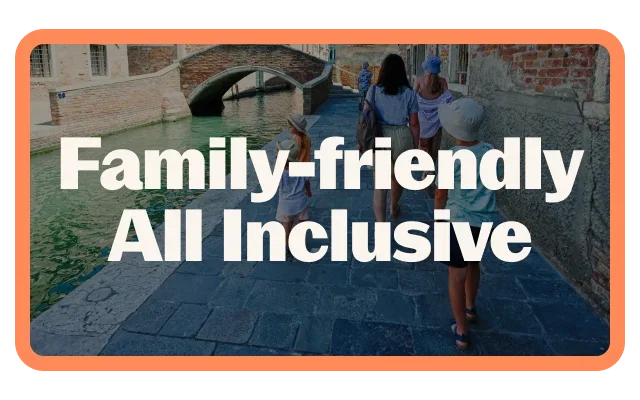 Coral-orange border, 'Family-friendly All Inclusive' white bold text, European canal scene, stone bridge, four people walking, grey flagstone walkway, green canal water, historic brick buildings, aged architecture and rounded corners.