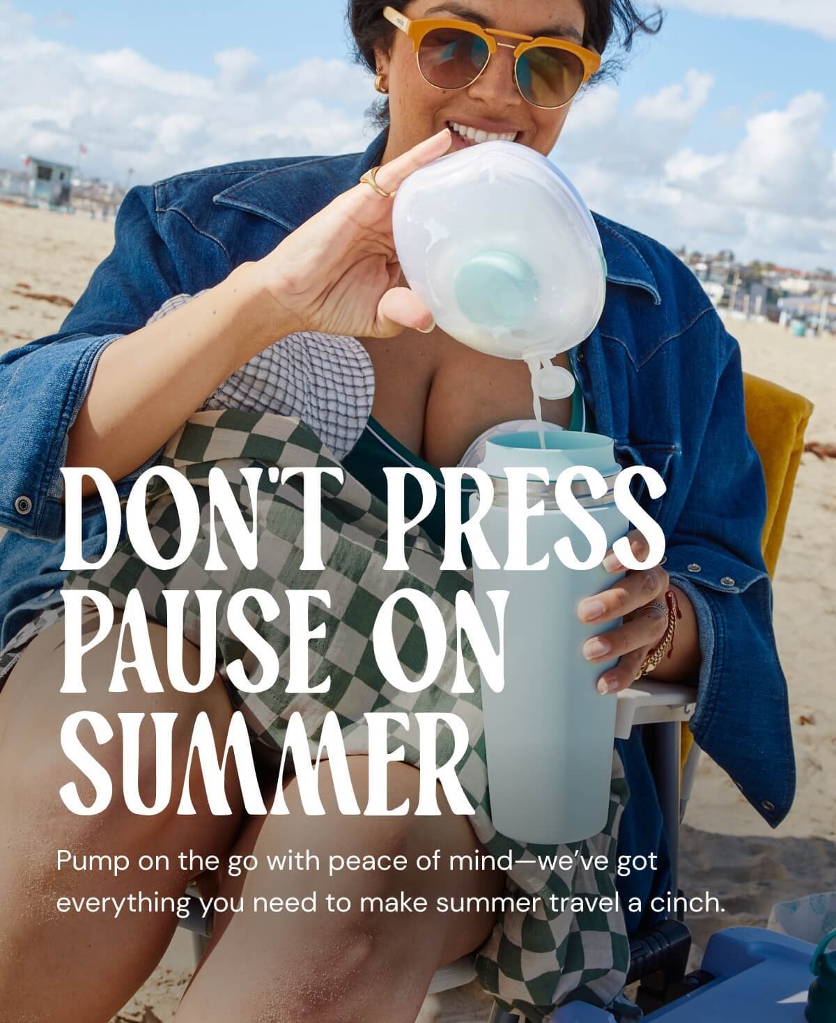 Woman pouring drink into tumbler at the beach with don't press pause on summer text