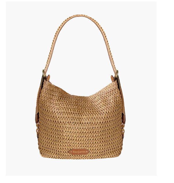 Woven straw handbag with a single shoulder strap and a leather logo patch.