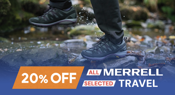 20% Off All Merrell, 20% off Selected Travel. A woman walks through a puddle wearing Merrell Women's Siren Sport GORE-TEX Walking Shoes in Black/Blackberry.