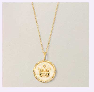 Gold chain necklace with butterfly coin medallion pendant.