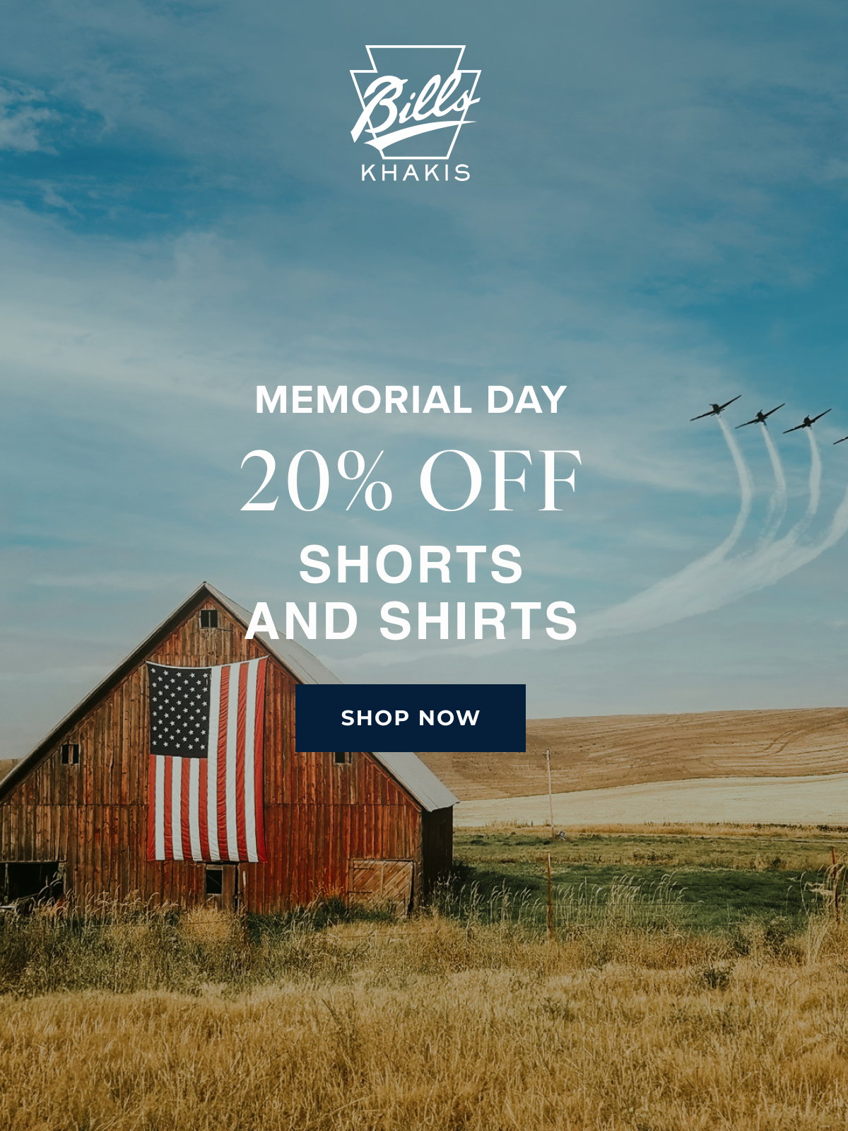 A background photo shows rustic barn with an american flag amongst a rustic, midwest barren landscape with planes or jet streams in the distance. The Bills Khakis logo overlays the photo with text that reads: Memorial Day | 20% Off | Shorts and Shirts | Shop Now