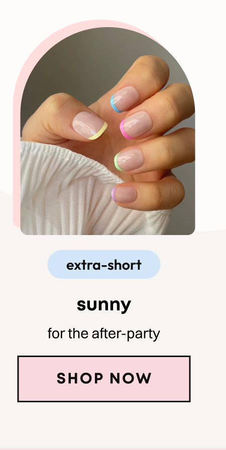 Hand showing colorful rainbow French tip press-on nails with pastel accent colors