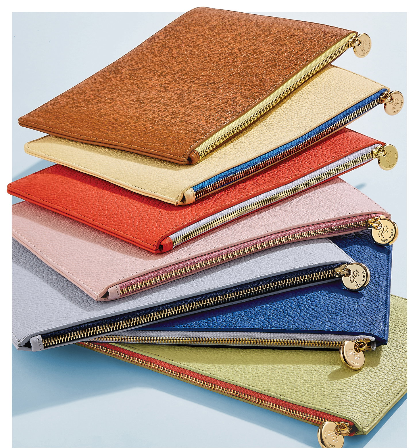 The Birdie Pouch in Tan, Chiffon, Coral, Pink, Periwinkle, Cobalt, and Celadon.