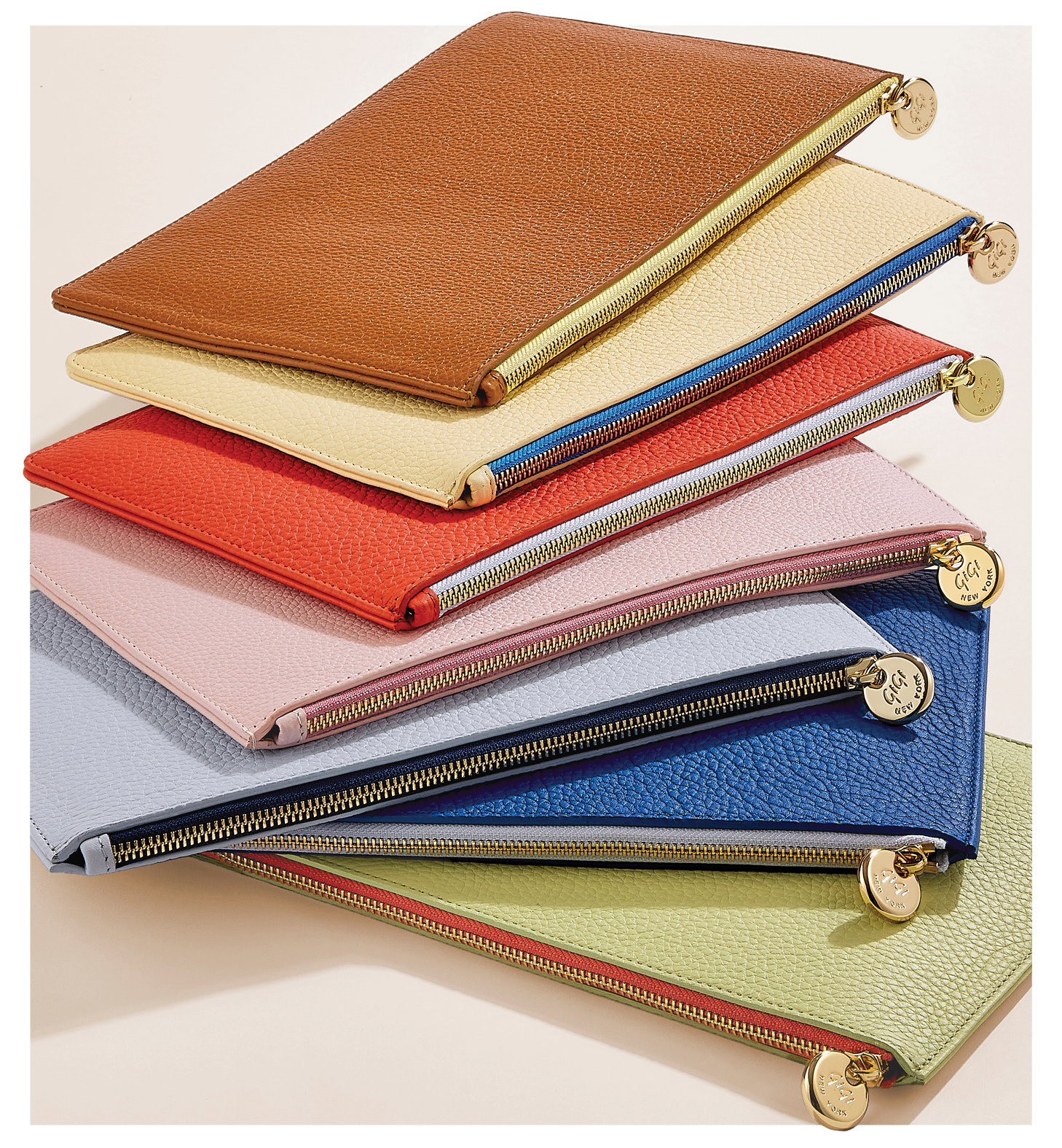 The Birdie Pouch in Tan, Chiffon, Coral, Pink, Periwinkle, Cobalt, and Celadon.