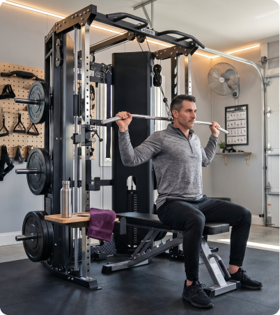 Man working out on Force USA C10 All-In-One Trainer in home garage
