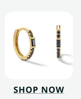 Gold huggie hoops featuring a central black baguette-cut stone flanked by small round black stones. Click here to shop now