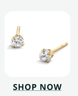 A pair of classic gold stud earrings featuring round, brilliant-cut white stones in a four-prong setting. Click here to shop now