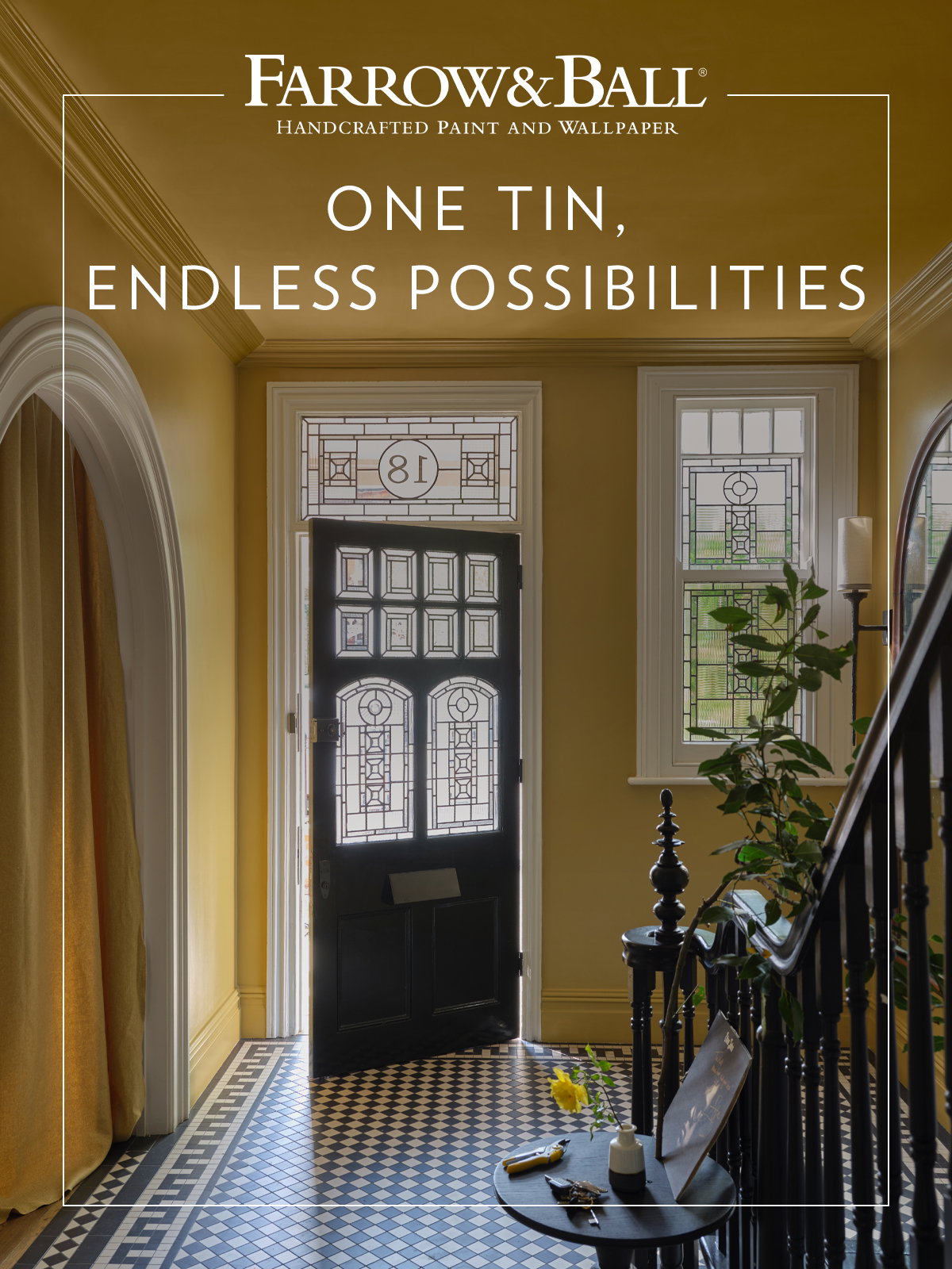 Warm hallway painted in golden yellow with black door and patterned floor tiles.