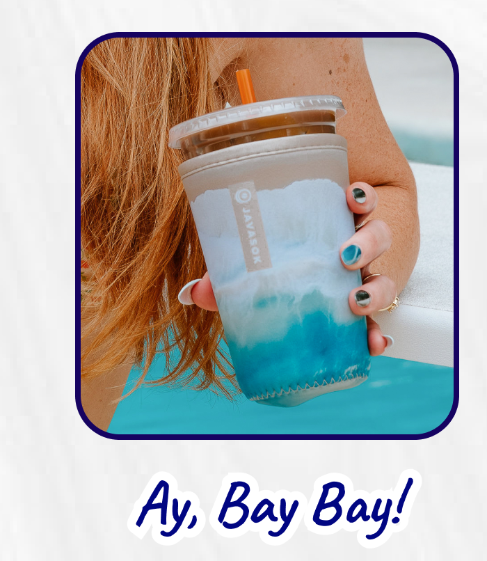 Person holding a blue iced drink tumbler sleeve.