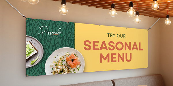 A large yellow banner reading “Seasonal Menu” is mounted on an interior wall in a restaurant.