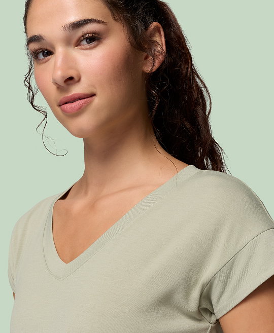 Woman wearing green v neck shirt.
