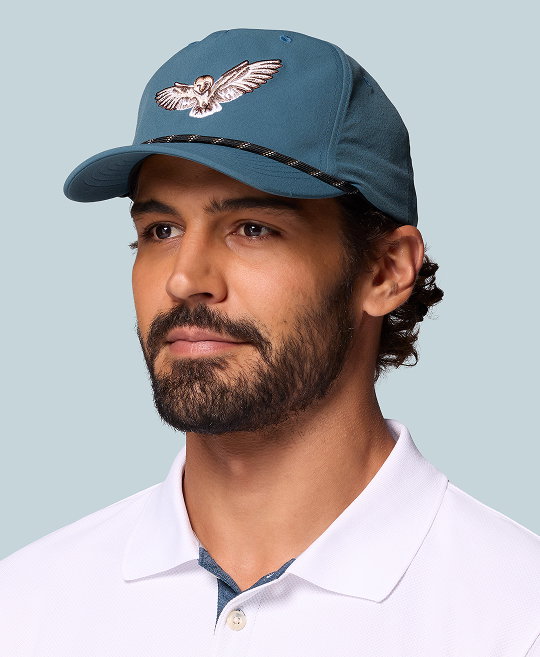 Man wearing blue Columbia hat with rope brim.