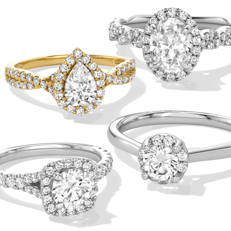 Assorted diamond engagement rings in white and yellow metal, featuring oval, pear, and round center stones with halo and pavé bands.