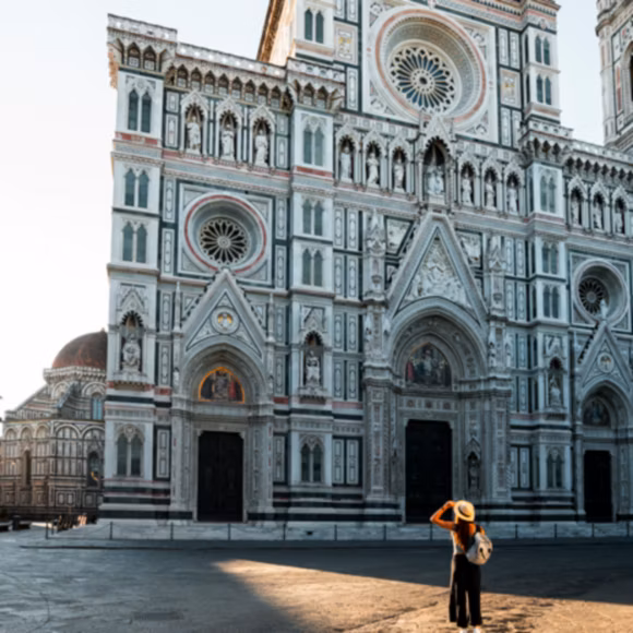 A visitor admiring the façade of the Cathedral of Santa Maria del Fiore, Italy, linking to BA High Life site.