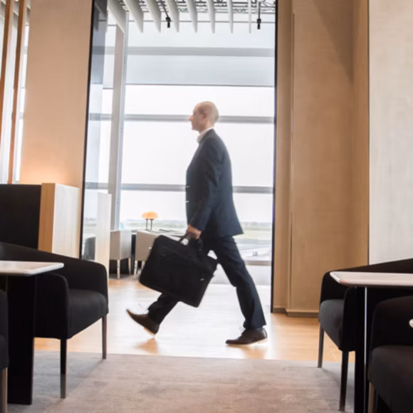 A business traveller in the Rome lounge, linking to BA High Life site.