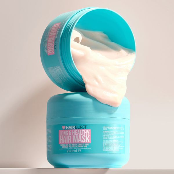 Turquoise container of Hairburst hair mask with creamy product spilling out.