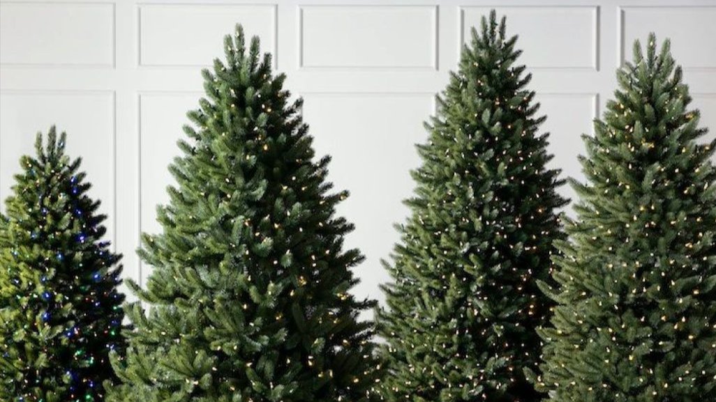 Variety of prelit artificial Christmas trees in different heights
