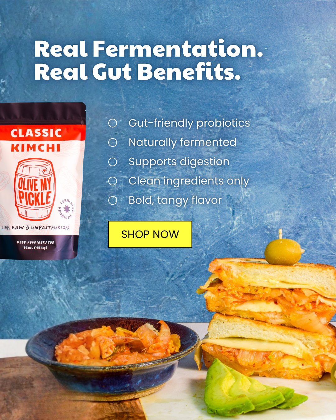 Pouch of Olive My Pickle Classic Kimchi, bowl of kimchi, kimchi grilled cheese sandwiches with avocado on a board, against a blue background. Text highlights fe