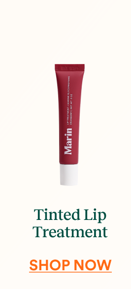Deep red Marin Tinted Lip Treatment tube centered on a neutral background with text below reading “Tinted Lip Treatment” and “Shop Now.”