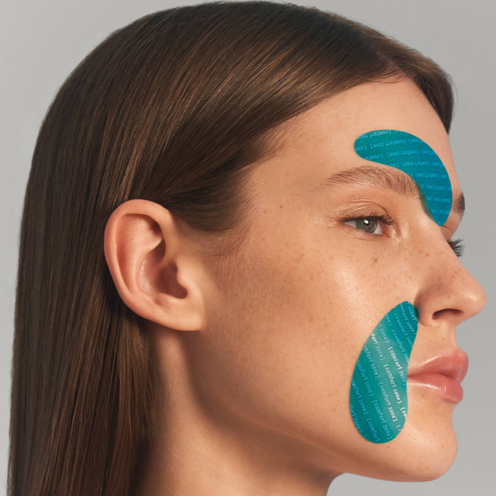 Woman wearing eye patches on her smile lines and frown lines