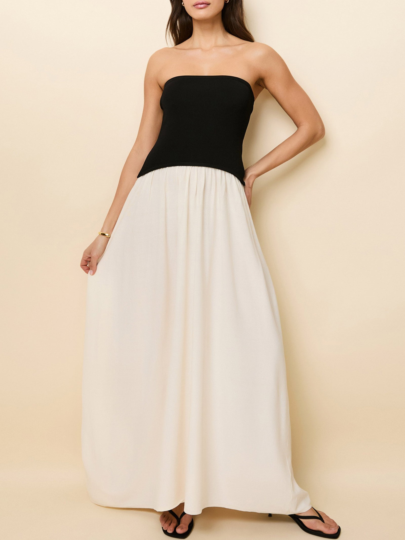 Woman in black and cream maxi dress